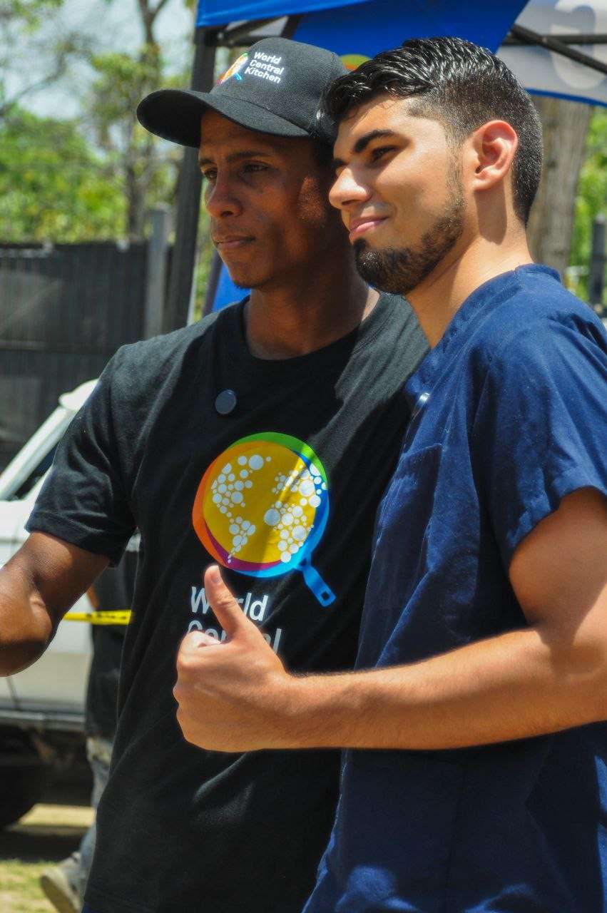 Orlando Briceño beside a World Central Kitchen volunteer